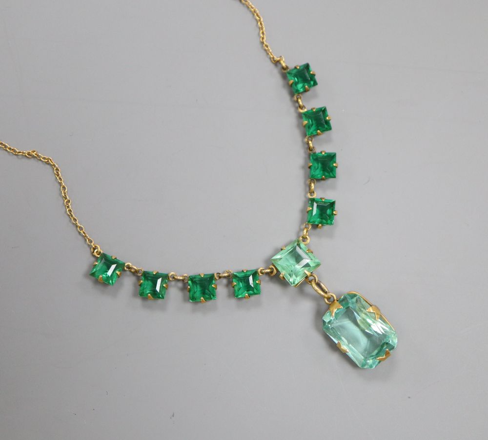 A green stone set necklace, the chain stamped 18ct